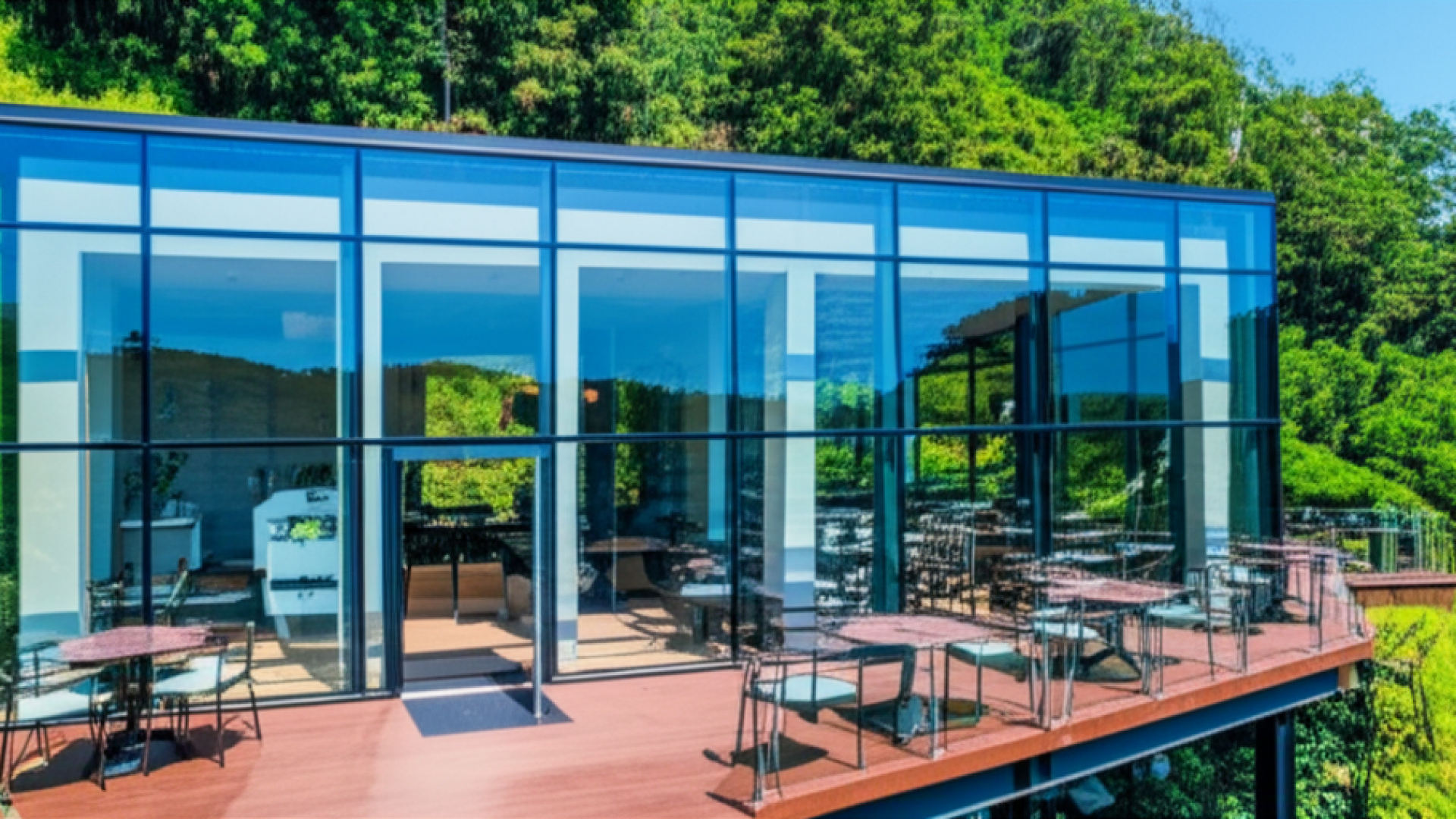 A modern glass-walled cafe nestled on a lush green hillside in Taoyuan, Taiwan, during a bright sunn