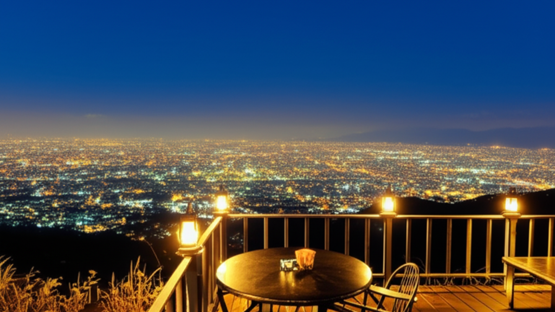 A breathtaking night view from a hilltop cafe in Taoyuan, showing a sea of golden city lights stretc
